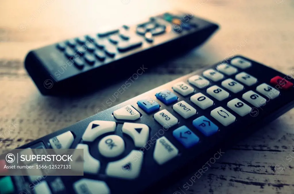 TV remotes on a table.