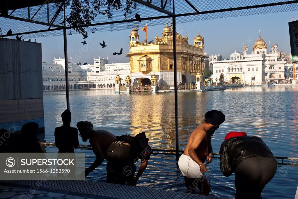 Pilgrims preparing to bathe in the lake, The Golden Temple of Amritsar, aka The Harmandir Sahib or Hari Mandir Punjab, India