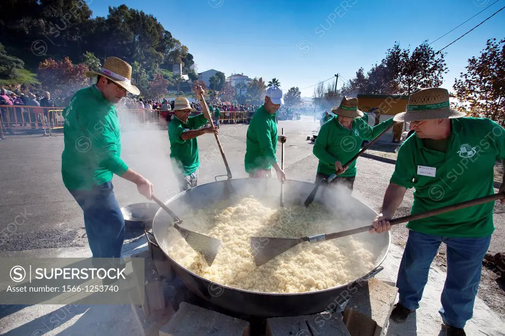 Group of men making crumbs  The crumbs are a traditional meal and delicious Andalusian  The Festival of the Crumbs in Torrox  Malaga, Andalusia, Spain...