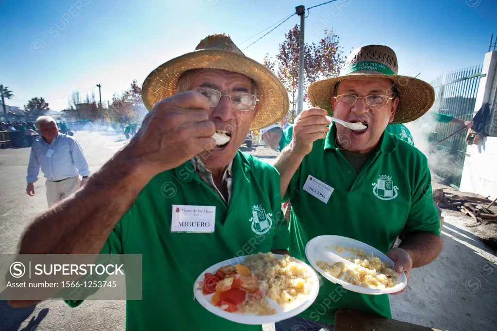 Men eating crumbs  The crumbs are a traditional meal and delicious Andalusian  The Festival of the Crumbs in Torrox  Malaga, Andalusia, Spain, Europe