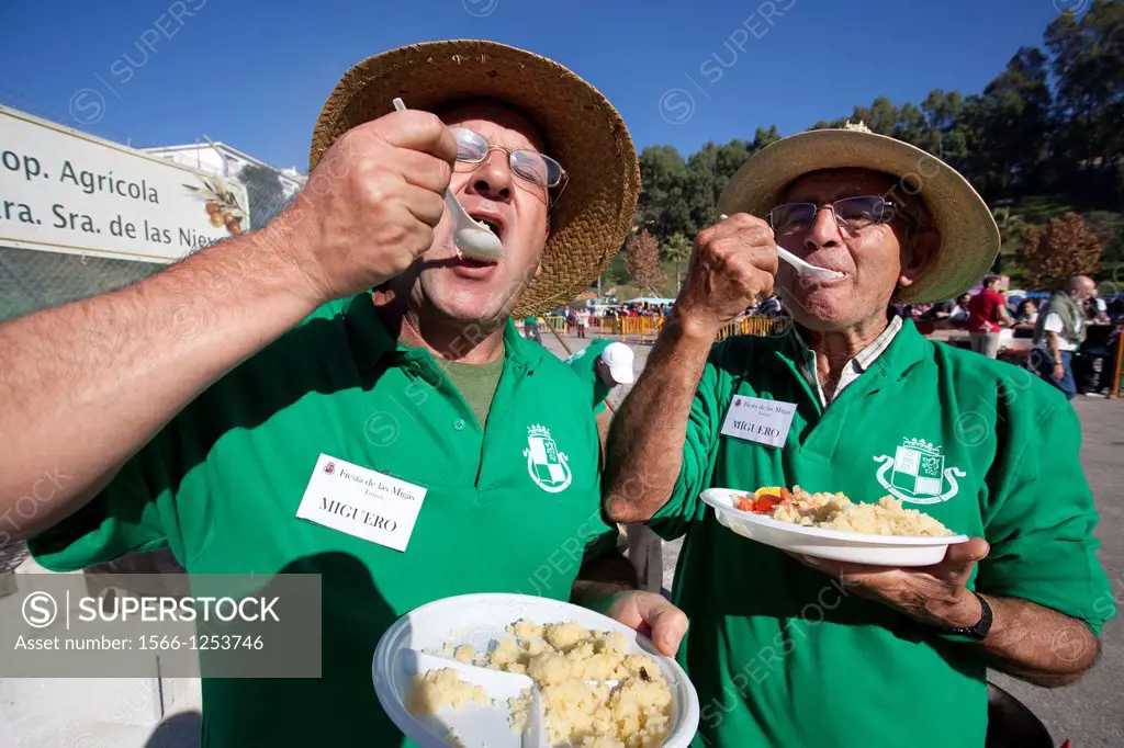 Men eating crumbs  The crumbs are a traditional meal and delicious Andalusian  The Festival of the Crumbs in Torrox  Malaga, Andalusia, Spain, Europe