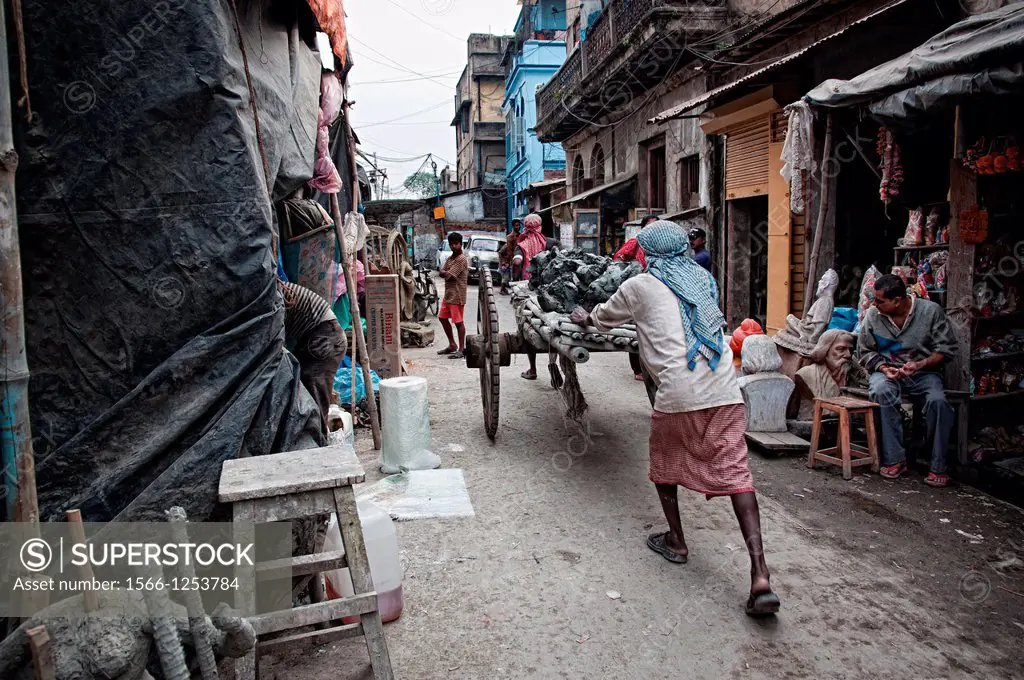 Men pussing carts full of mud in Kumartuli district  Calcutta, West Bengal, India