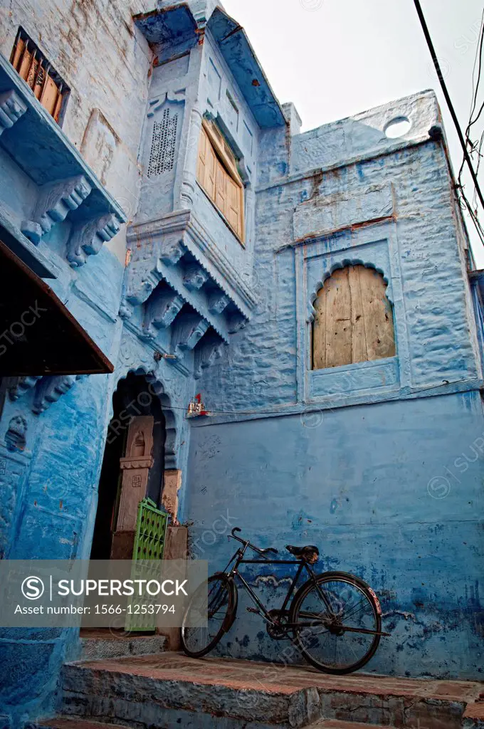 Bicycle parked against a blue painted residential haveli  Jodhpur, Rajasthan, India