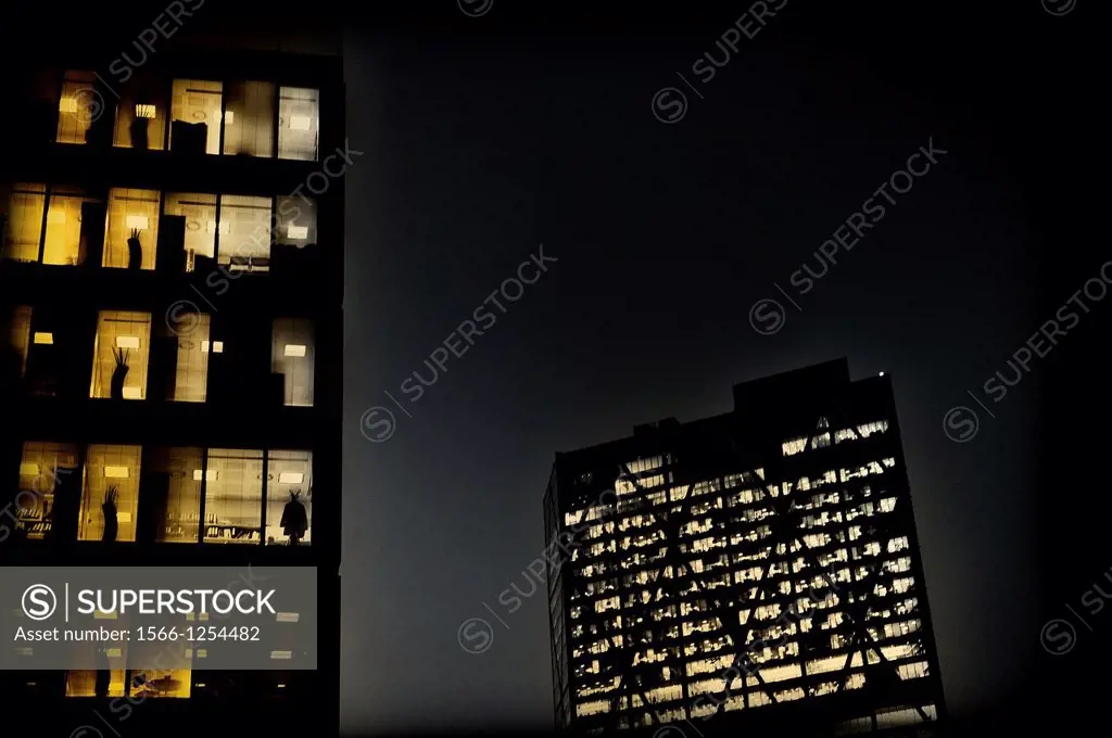 Office buildings with lights on in Liverpool Street, London, England, UK