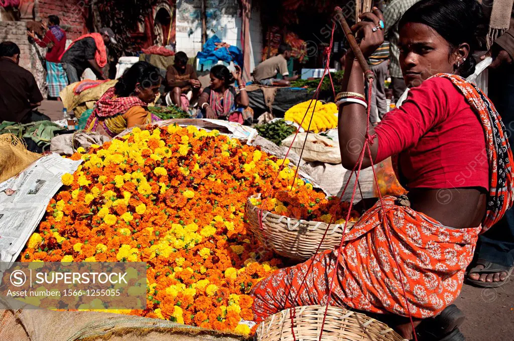Woman selling flowers in Mullik ghat flower market  Calcutta, West Bengal, India