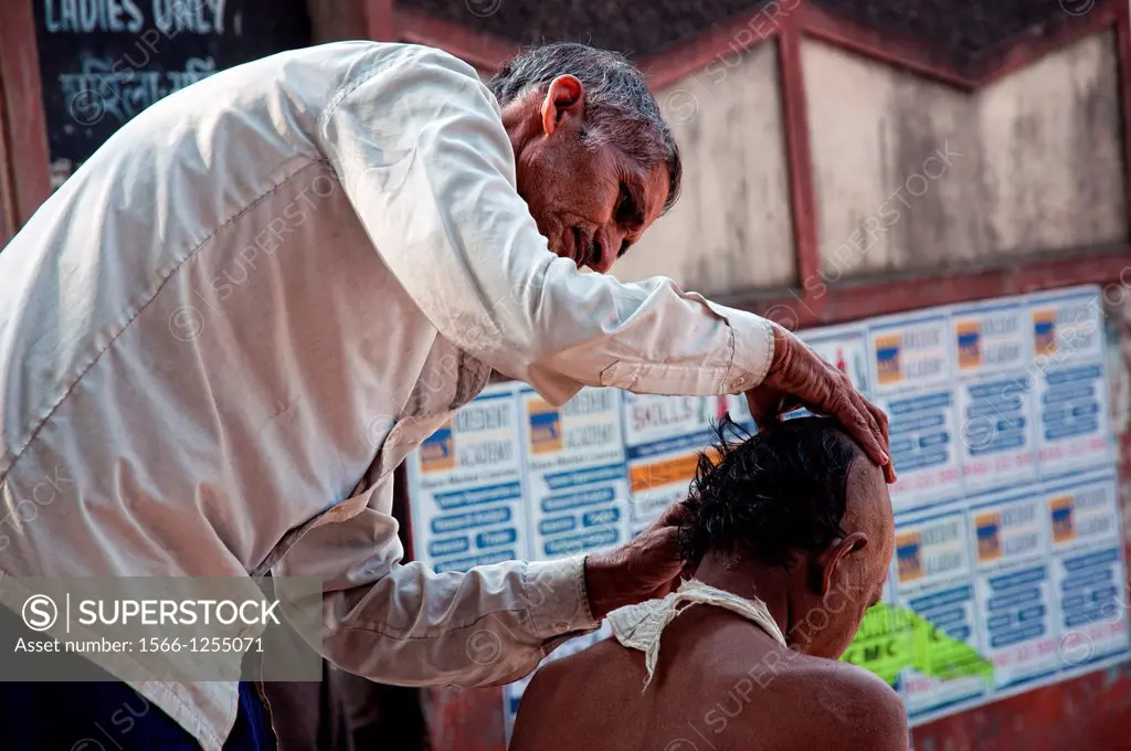 Man having a hair shave  Calcutta, West Bengal, India