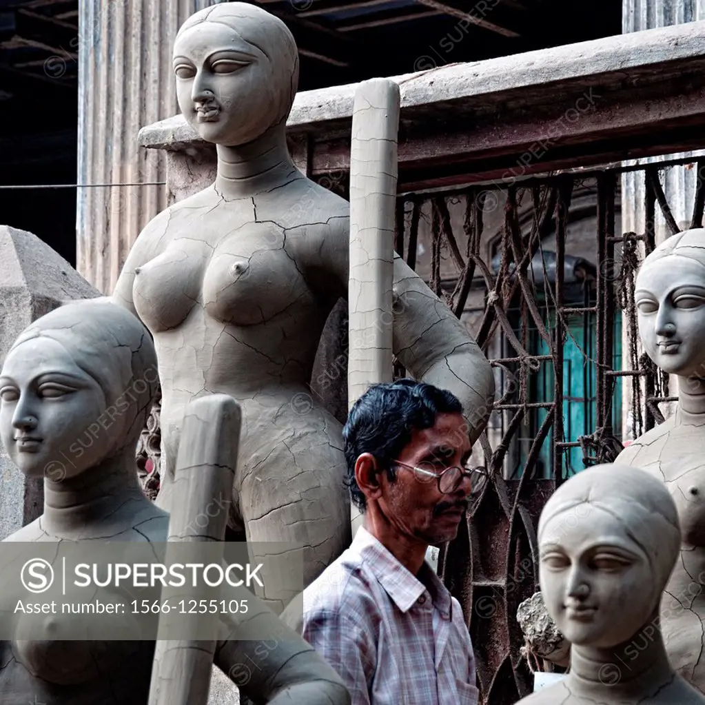 Man making effigies of gods in a workshop in Kumartuli district, Calcutta, West Bengal, India