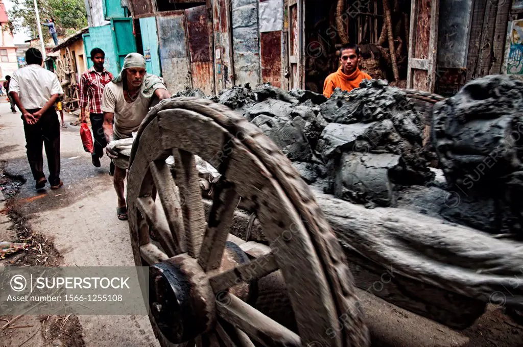 Men pussing carts full of mud in Kumartuli district  Calcutta, West Bengal, India