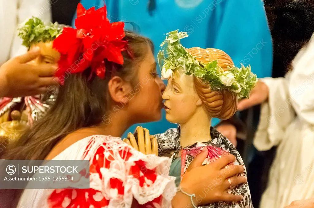 Europe, France, Bouche-du-Rhone, 13, Saintes-Marie-de-la-Mer, pilgrimage of gypsies  Young girl kissing the saints