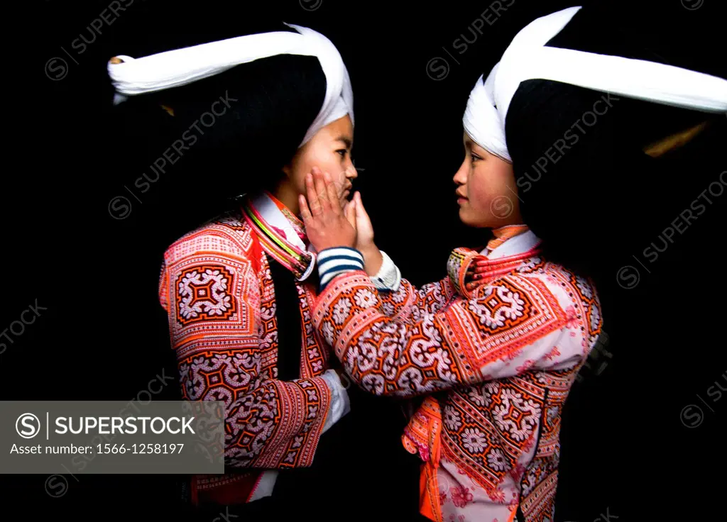 Long Horn Miao teenage girls put makeup on each other as preparation for the Tiao Hua festival
