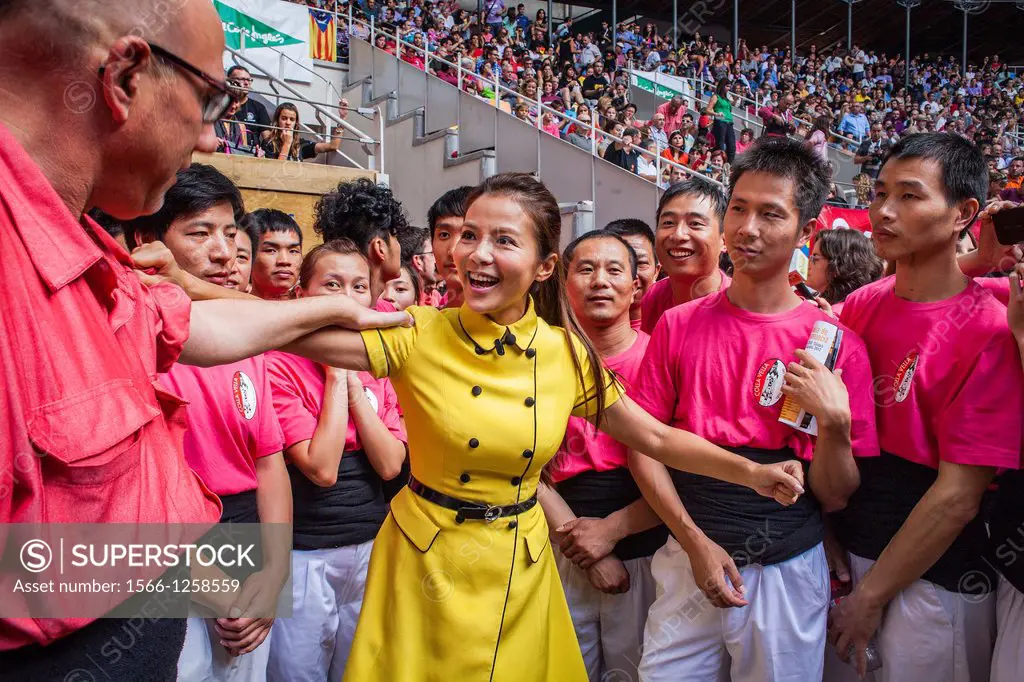 Chinese journalist jokes with man of Colla Vella Xiquets de Valls ´Castellers´ building human tower, a Catalan tradition Biannual contest  bullring Ta...