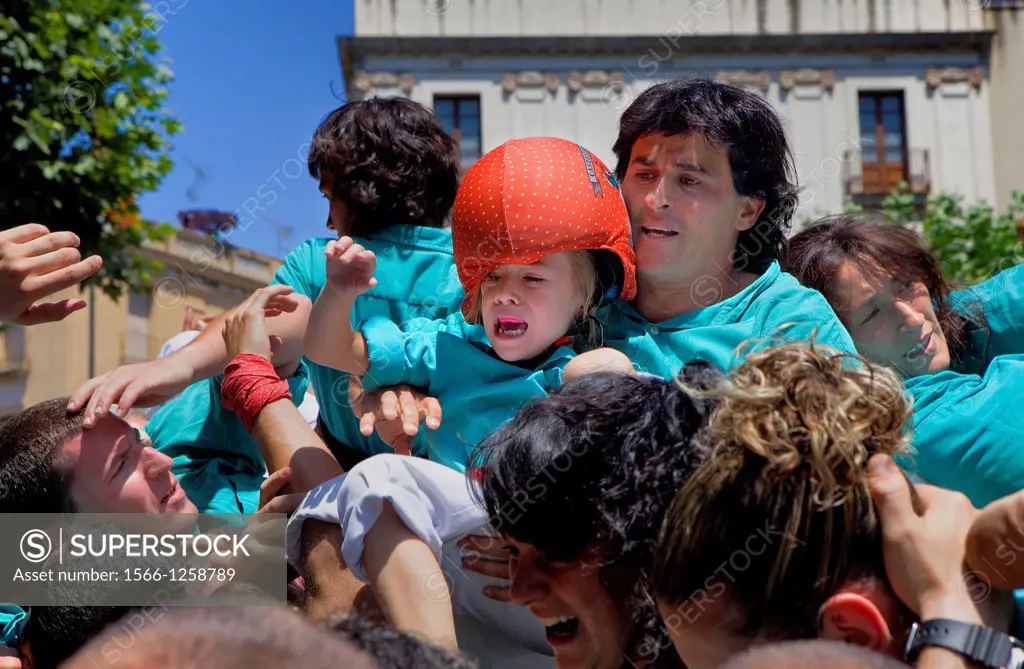 `Enxaneta´girl who rises to the top of the human tower  Castellers de Vilafranca after the fall of the human tower ´Castellers´ is a Catalan tradition...