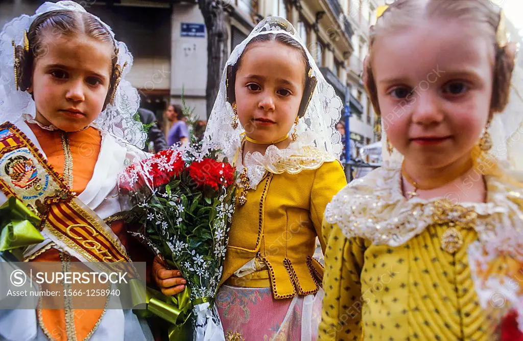 Flower offering,Girls with Floral tribute to `Virgen de los desamparados´,Fallas festival,San Vicente Mertir street,Valencia,Spain