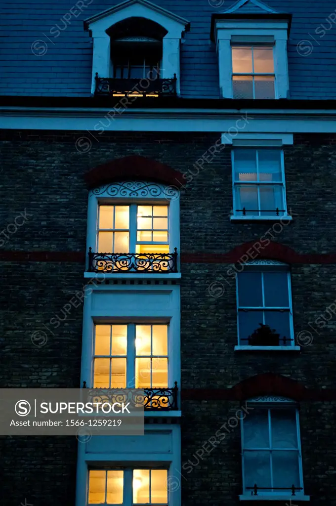 Lit windows at dusk, Chelsea Bridge Road, London, SW3, UK
