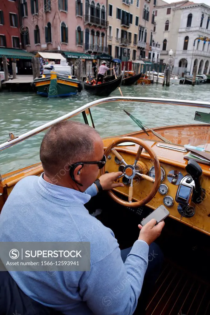 Italy, Venice, in a water taxi (motoscafo) on the canals.