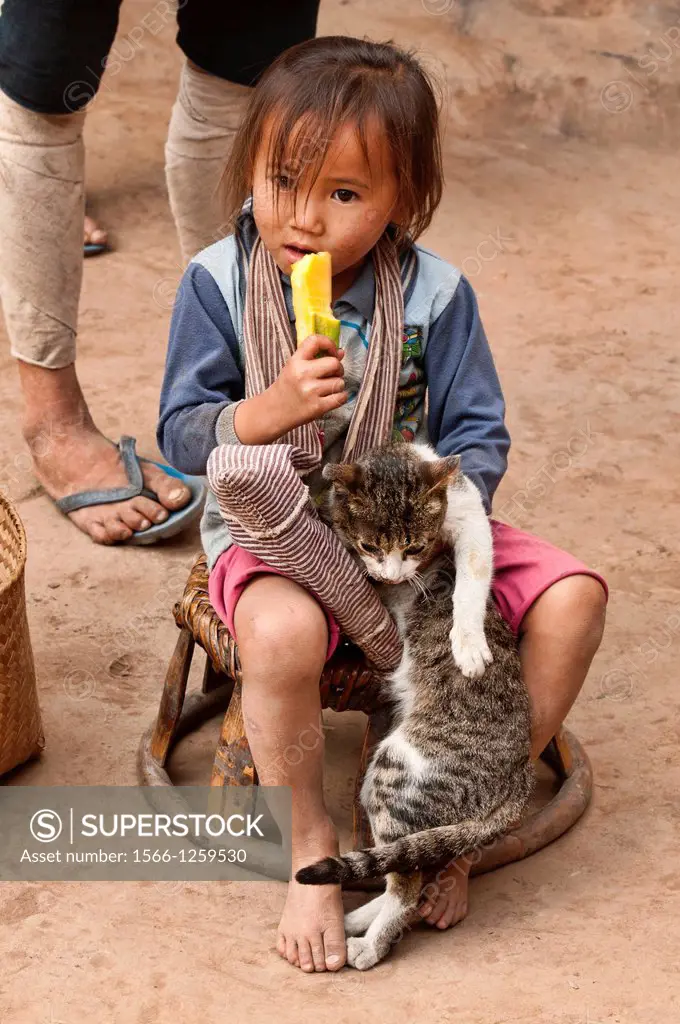 Ethnic Lanten girl with cat and popsicle, Luang Nam Tha, Laos