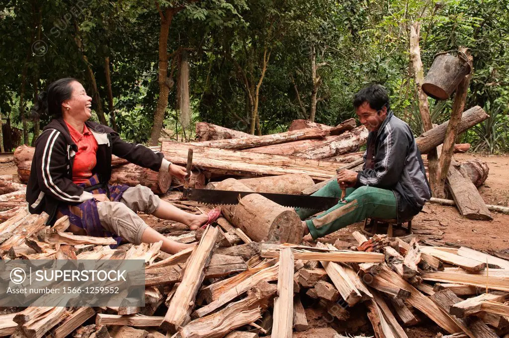 ethnic Khmu couple enjoying cutting wood, Luang Nam Tha, Laos