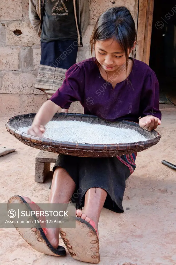 ethnic Khmu girl sifting rice, Luang Nam Tha, Laos