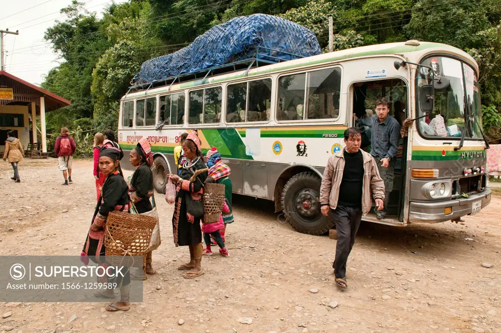 Akha women greeting a long distance bus enroute to Phongsaly, Laos