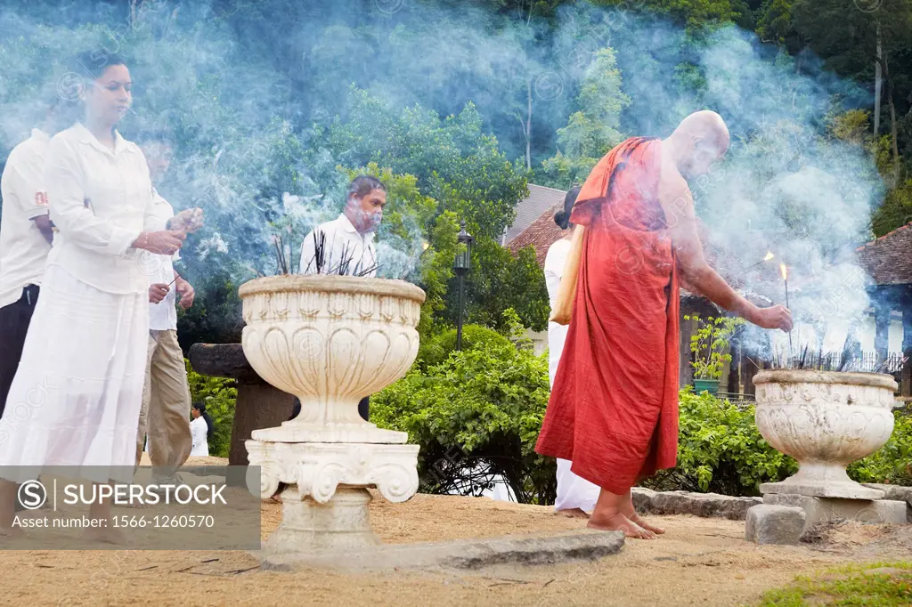 Sri Lanka - Kandy, Temple of the Tooth, Sri Dalada Maligawa, UNESCO World Heritage Site, monk light up incense offerings, central region of Sri Lanka ...