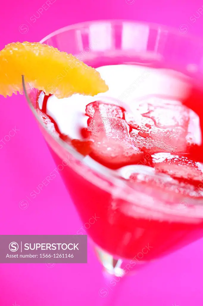 a beautiful cranberry juice with ice and orange slice