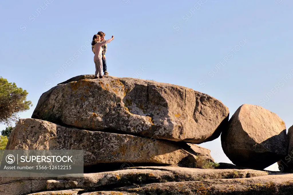 Two people on a rock. Costa Brava. Cap Roig coast. Girona. Catalonia. Spain.