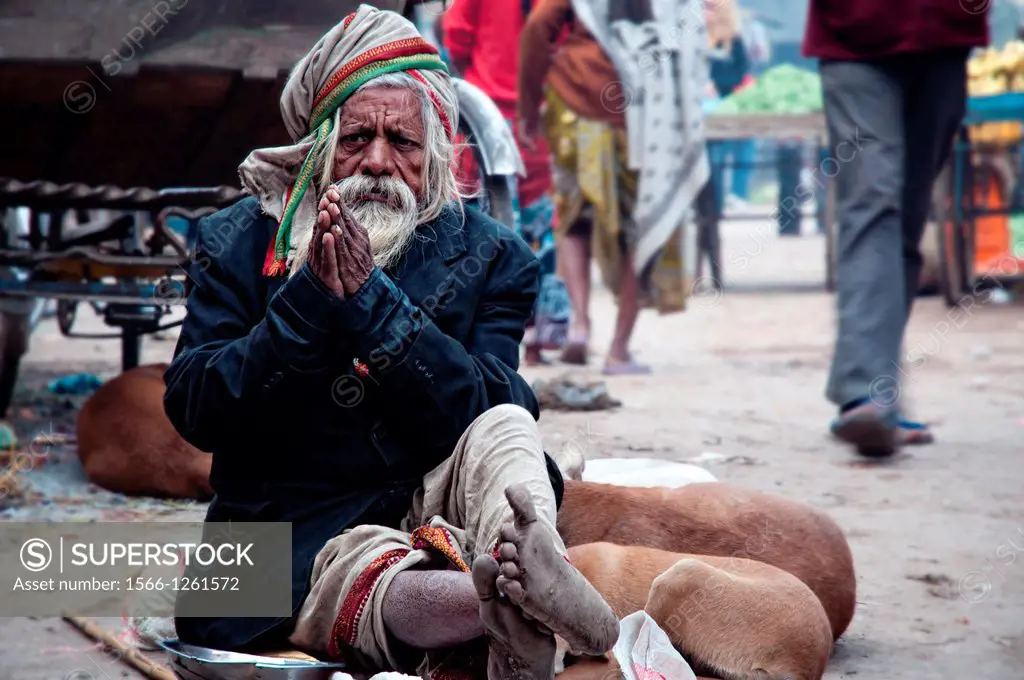 Man begging in the streets of the old town Varanasi, Benares, Uttar Pradesh, India