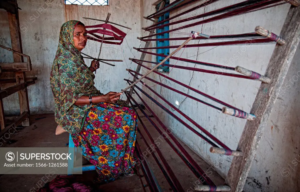 Woman weaving with a foot - treadle wooden loom in Bhuj area  Kutch, Gujarat, India