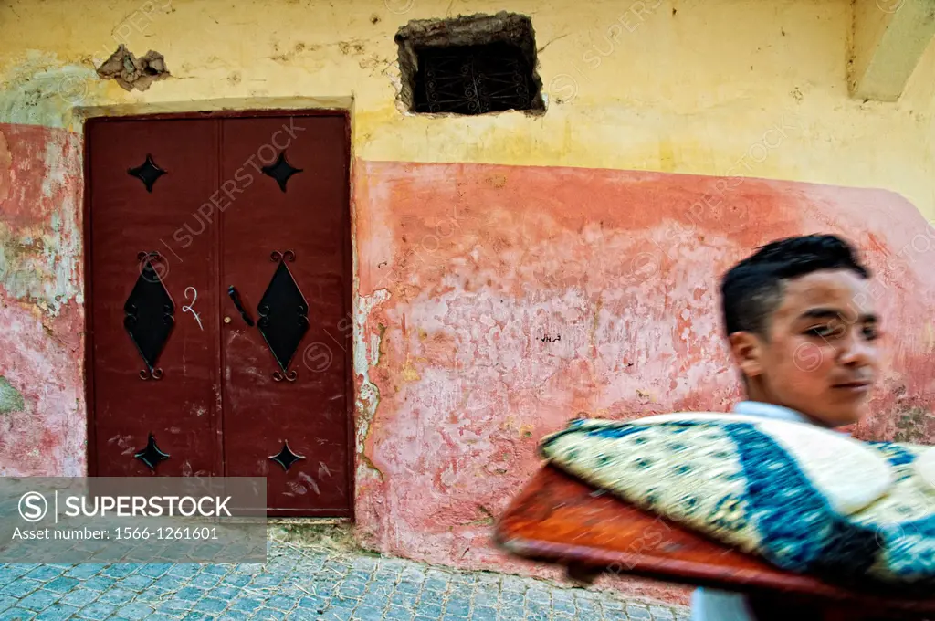 Boy bringing bread to the oven. Moulay Idriss, Morocco