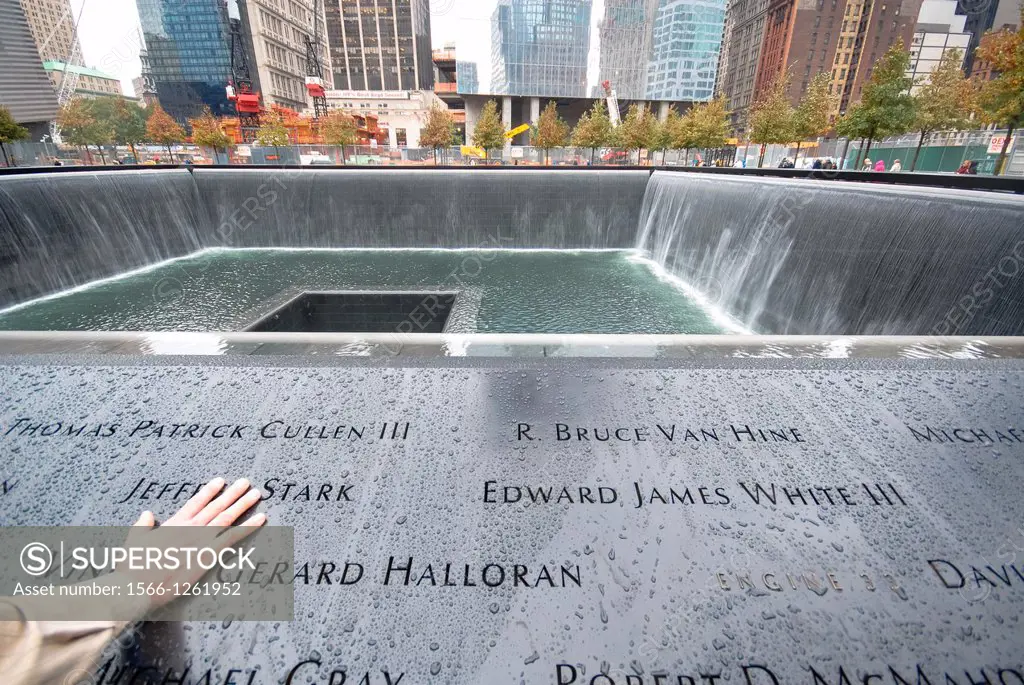 9/11 memorial, fountain, hand on inscripted names, Manhattan, New York