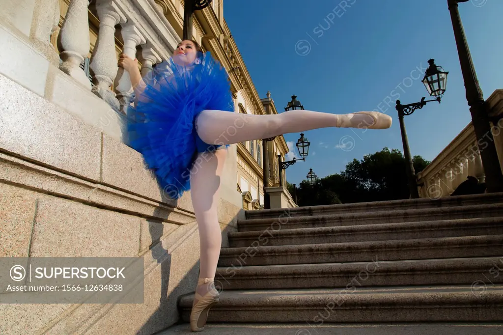 The dancer is in the park of Monza in Milan is dancing on the stairs of the royal house
