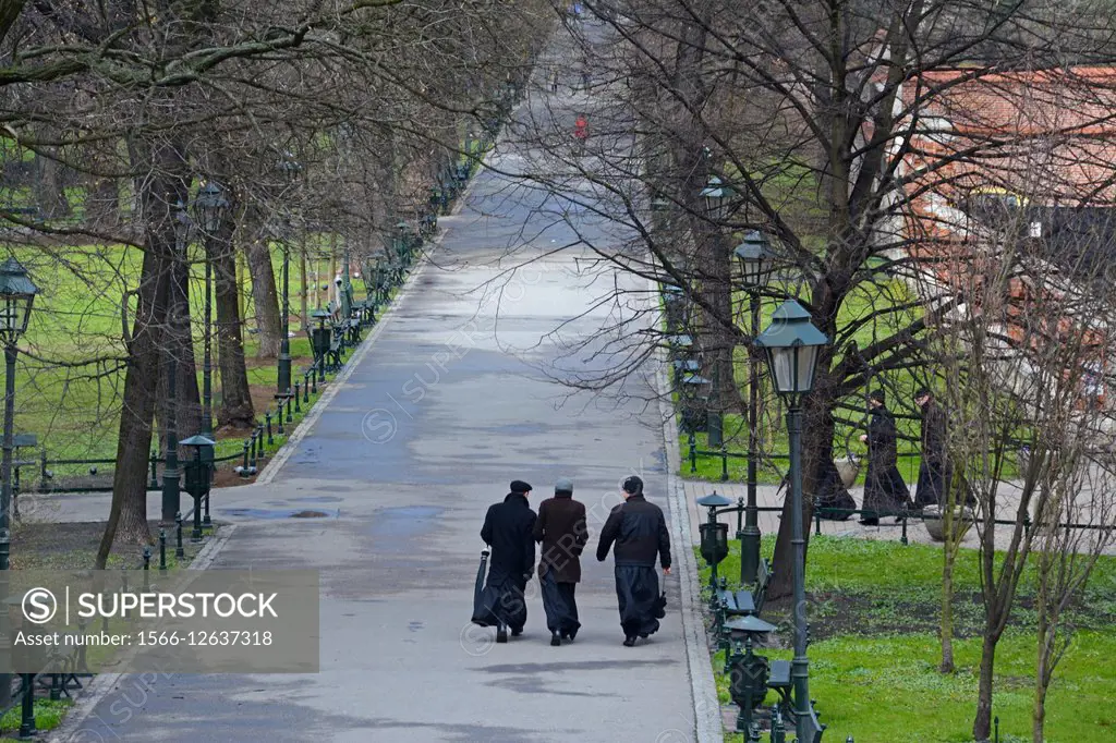 Priests walking in the Planty Park. Krakov, Poland, Europe.