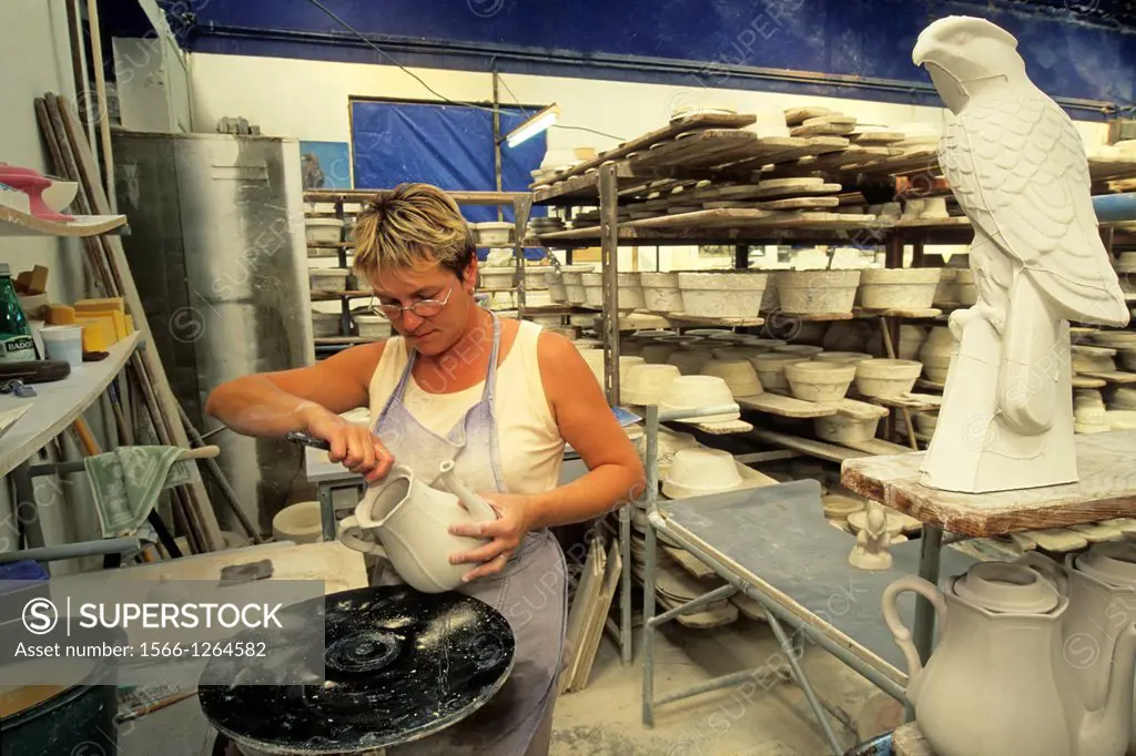 skilled worker deburring some pieces, earthenware factory of Niderviller, Moselle department, Lorraine region, France, Europe