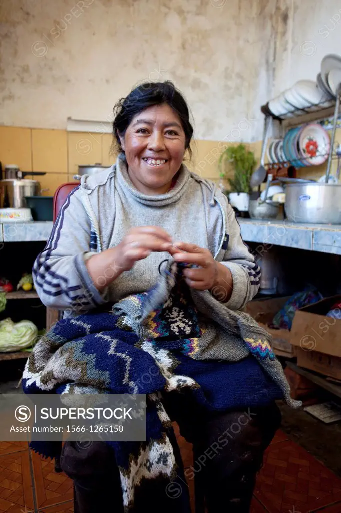 Ecuador, Salinas, Carmen Guaman wknitting for making sweaters.