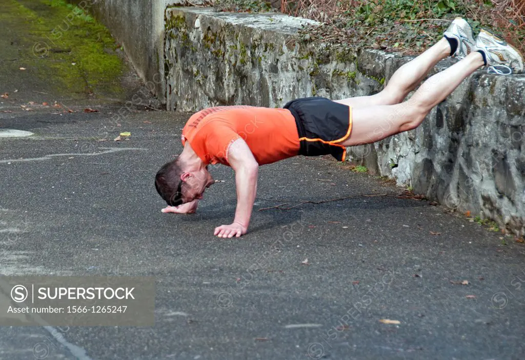 single man doing push-ups on the street, outdoor, Geneva, Switzerland, Europe