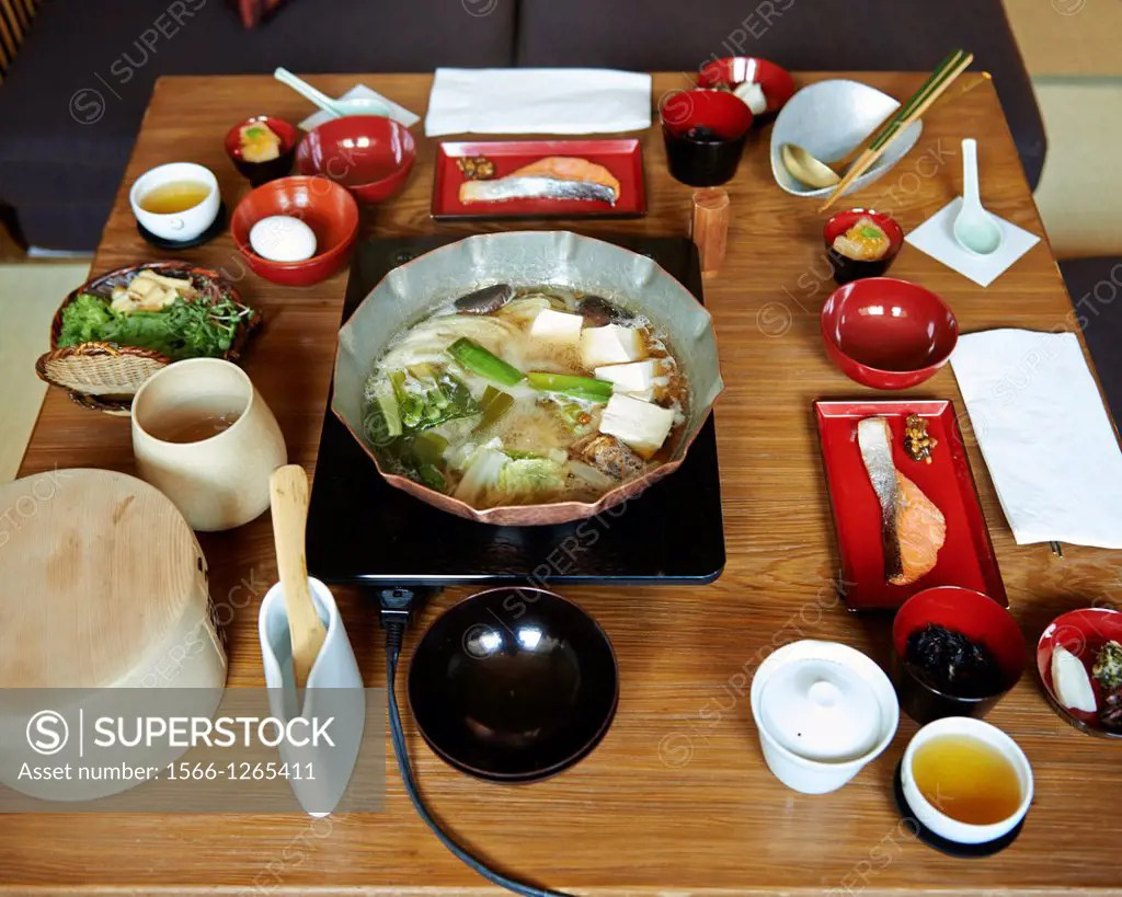 A traditional japanese breakfast consisting of various small dishes and a hot pot at a Ryokan, a traditional Japanese Inn