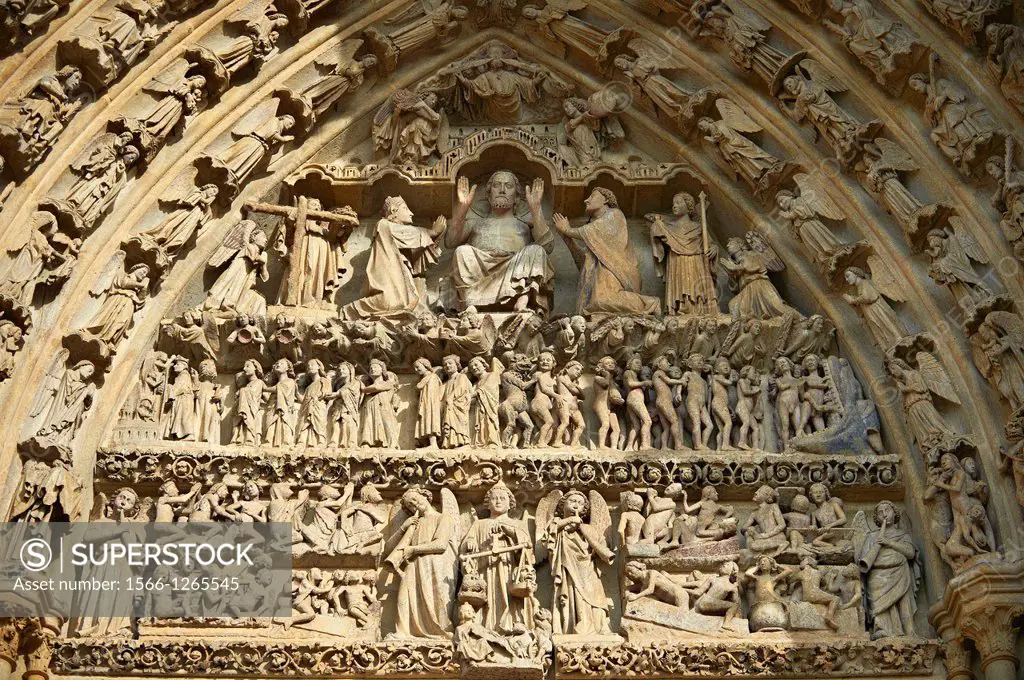 Tympanum of central west portal: Christ in Majesty presides over the Day of Judgement, supported by an array of saints. Gothic Cathedral of Notre-Dame...