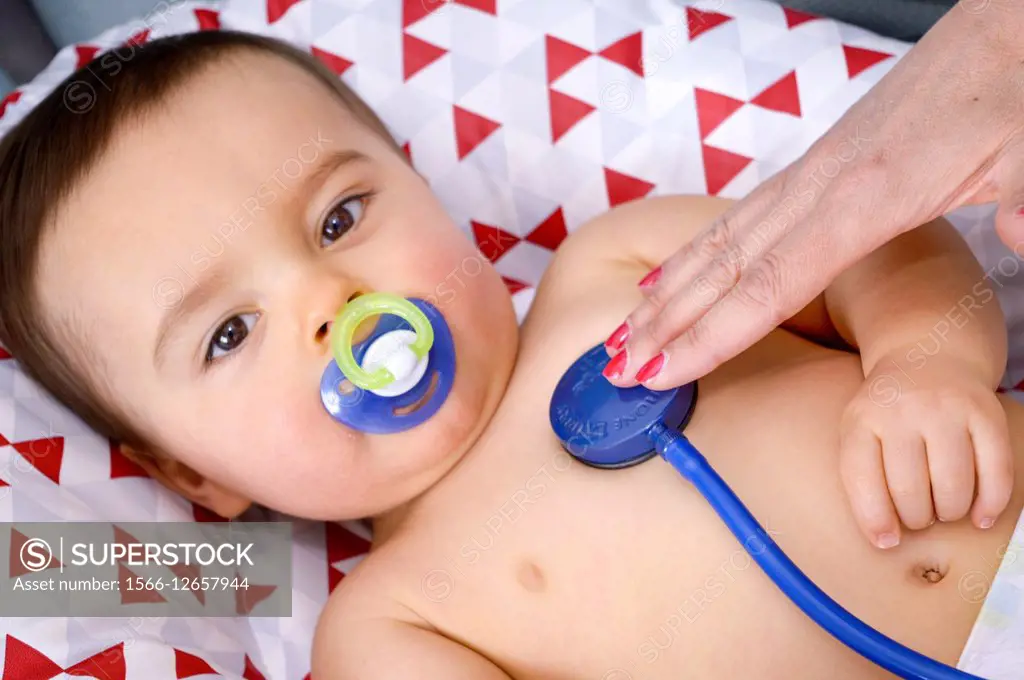 Doctor examining baby with a stethoscope (auscultation).