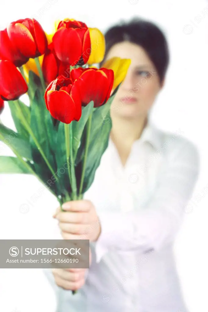 Young woman holding an artificial flower. . . .