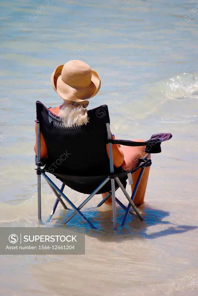 woman in chair in water