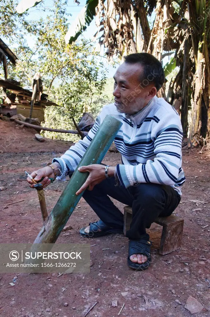 Hmong man and his bong water pipe, Luang Prabang, Laos