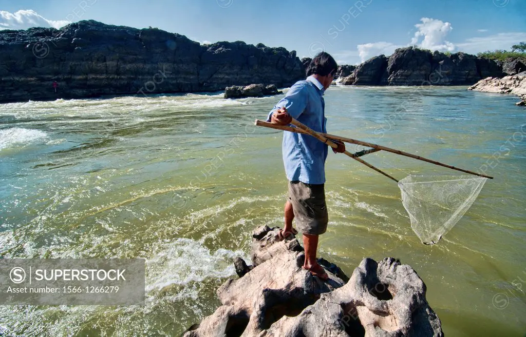 fisherman and his net in the Mekong River on Don Khone Island, Laos