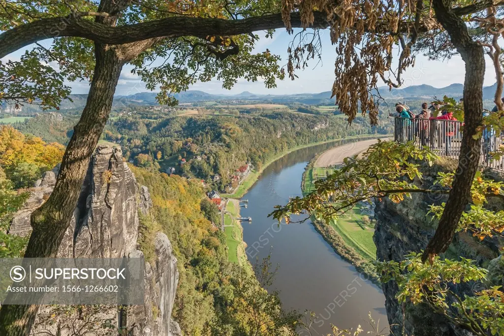 View from the spectacular rock formation Bastei (Bastion) to health resort Rathen and the Elbe River. The Bastei is one of the most visited tourist at...