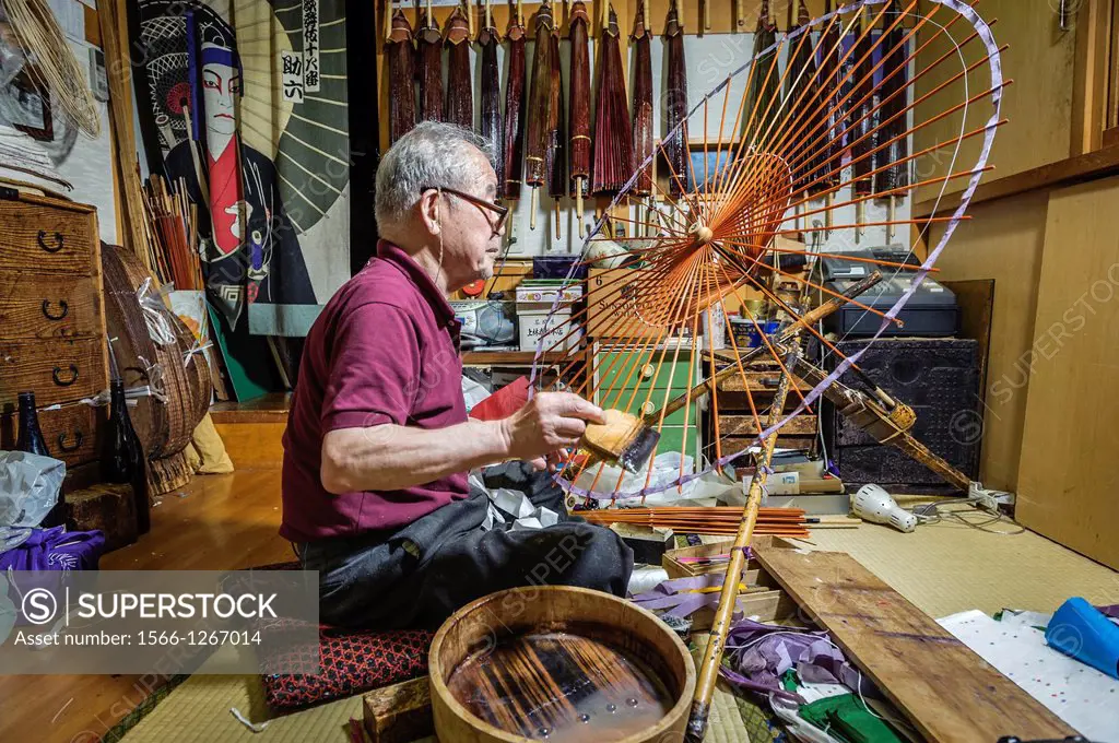 Mr Hiroshi Matsuda making wagasa, the Japanese, traditional umbrellas, in his workshop, Kanazawa, Honshu, Japan