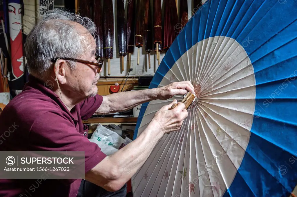 Mr Hiroshi Matsuda making wagasa, the Japanese, traditional umbrellas, in his workshop, Kanazawa, Honshu, Japan