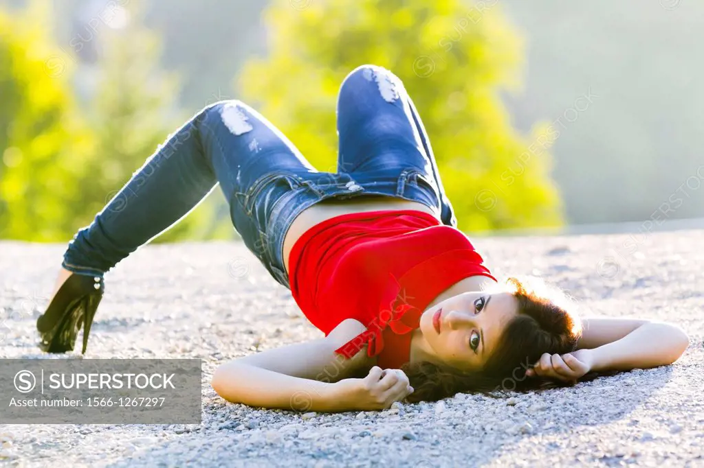 Awkward lying on ground young woman