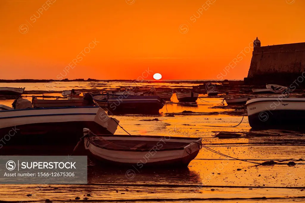 La Caleta beach and boats at sunset, Cadiz, Andalusia, Spain