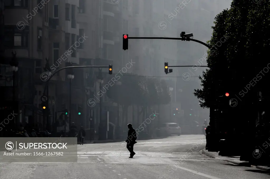 One man alone crossing Colon Street during the Fallas Mascletá, Valencia, Spain