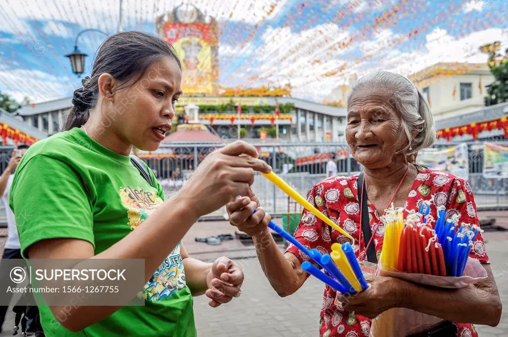 People praying in front of The Basilica Minore del Santo Niño, Cebu, Visayas, Philippines, South East Asia