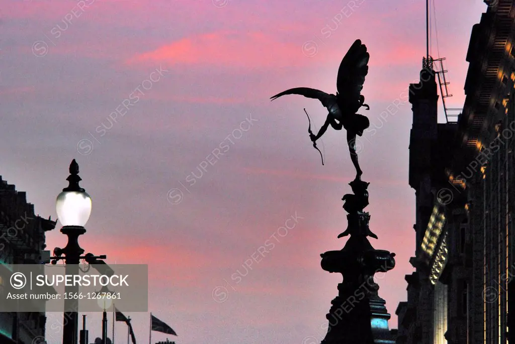 Statue of Eros in Piccadilly Cicus, seen looking westwards down Piccadilly, against a pleasant sunset, on a Spring evening in London, England.